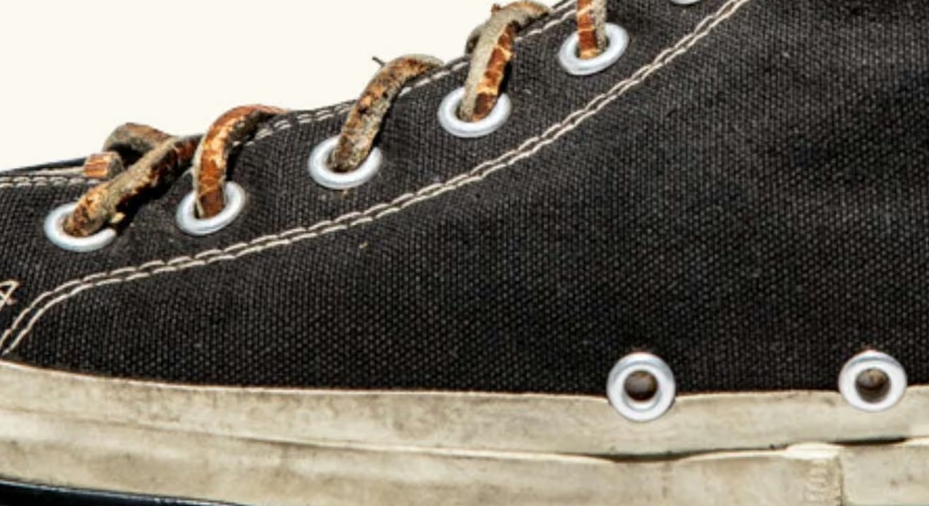 Close view of the laces, brass eyelets, the two ventilating eyelets at the instep and the rubber foxing