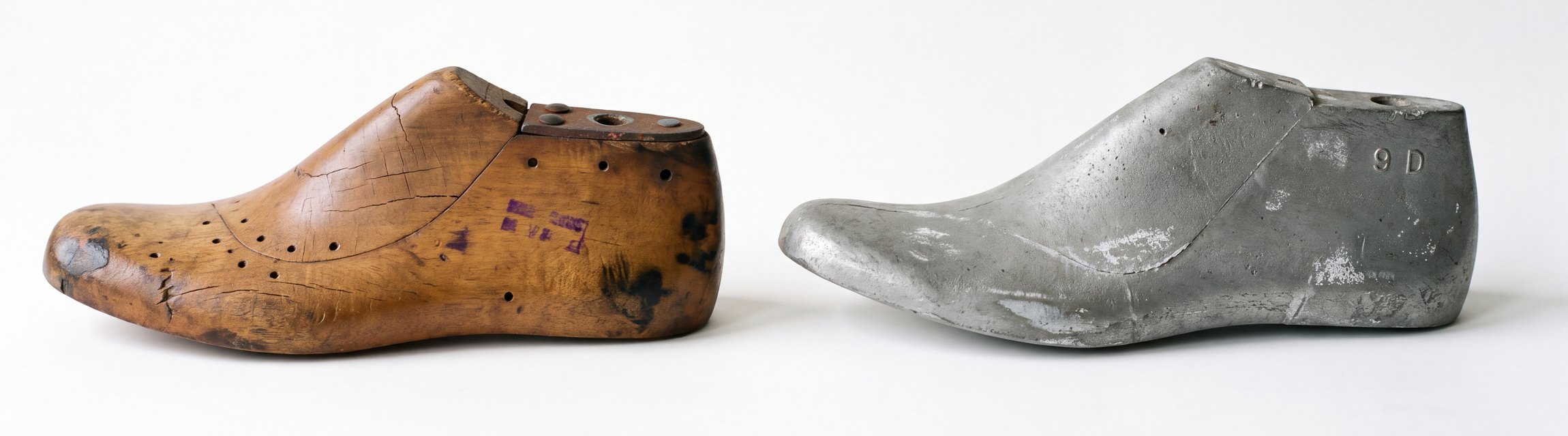 Two factory shoe lasts side by side on white: on the left a short, blunt-toed maple last, split and studded with tack holes, a rusted iron plate let into the top; on the right a longer, narrower one-piece aluminum casting, dull grey and pitted, the size 9 D raised on the heel