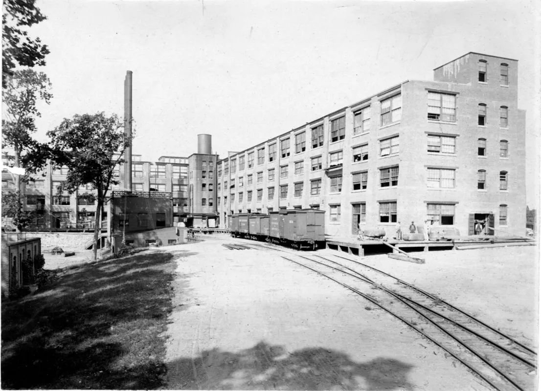 The long brick Hood Rubber Company plant at Watertown with a rail siding running alongside it