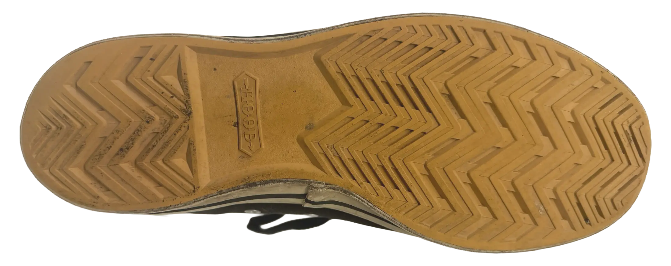 The full outsole of a 1955 Hood Conference: gum rubber moulded in one piece, herringbone tread running the length of the shoe, and the double-headed Hood arrow stamped into the arch.