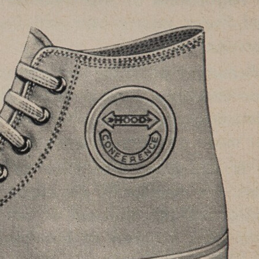 Detail of the 1957 artwork: the ankle disc drawn with HOOD inside the double-headed arrow and the word CONFERENCE curved around the lower arc of the ring.