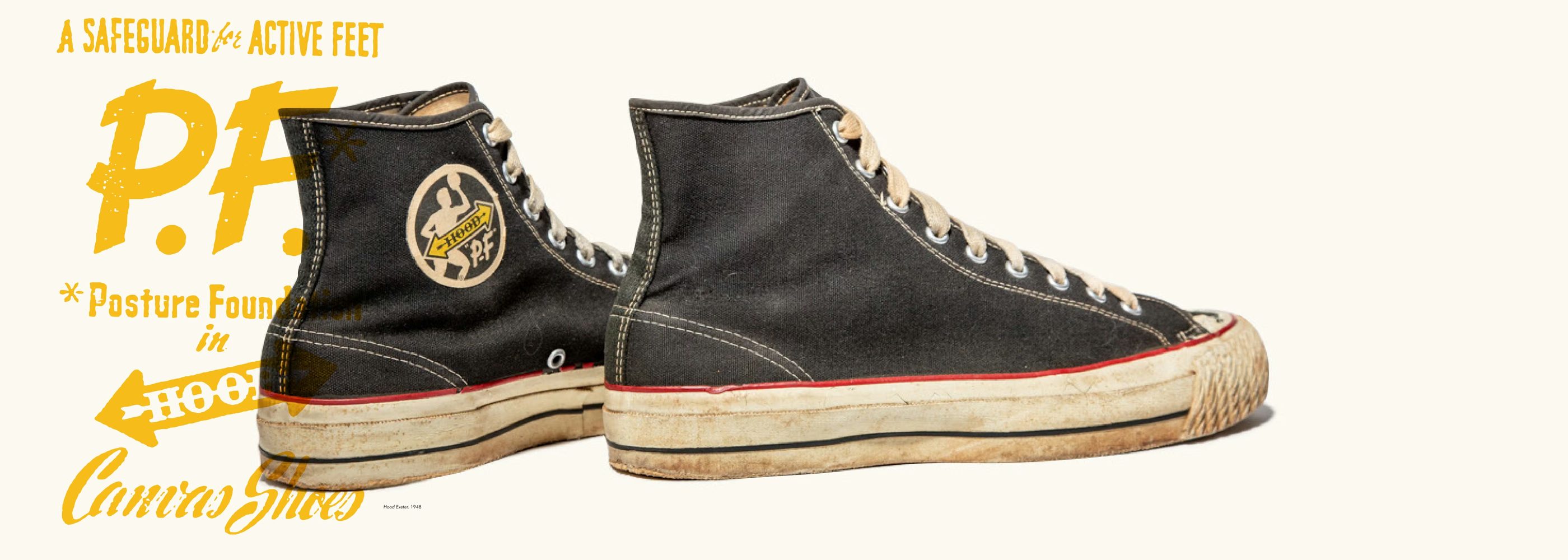 A black P-F Canvas Shoes high-top pair beside the Posture Foundation lettering